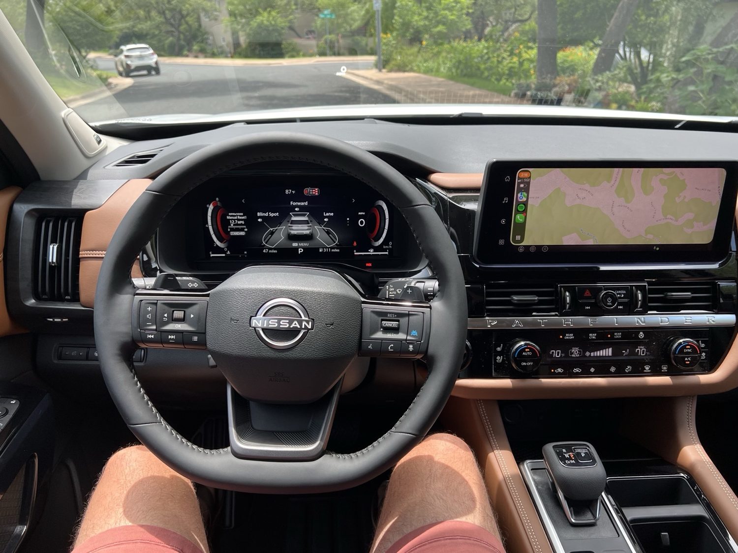 Pathfinder dashboard with steering wheel, center screen, climate panel, and shifter